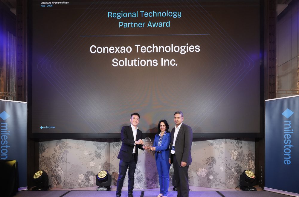 Conexao Technology Solutions receiving the Milestone Systems Regional Technology Partner Award on stage at Milestone XPerience Days Asia in Bangkok, May 2026